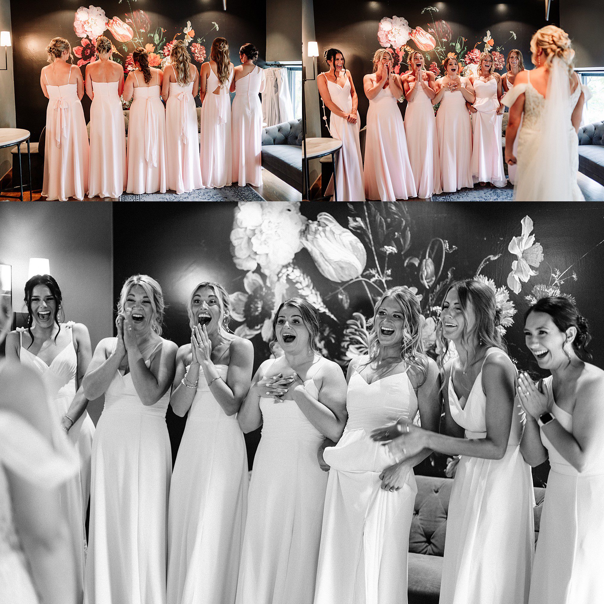 Six bridesmaids in white dresses react with excitement and joy as they see the bride in her wedding gown for the first time in a stylish, flower-decorated room at The Gibson Social Club wedding.