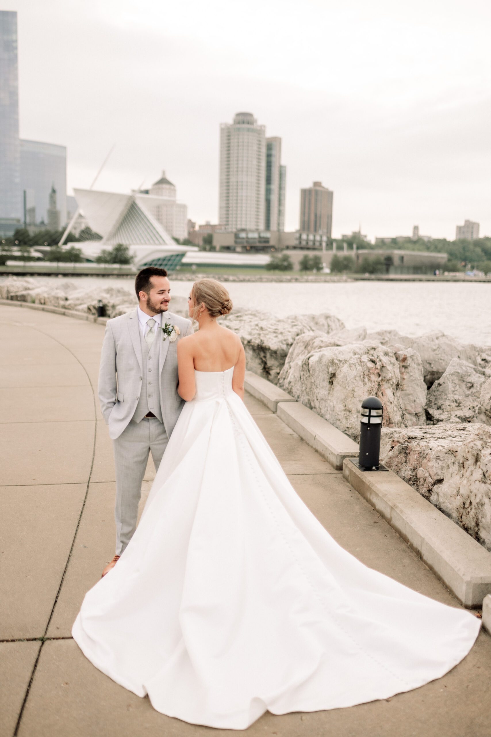 wedding couple overlooking Lake Michigan and the Milwaukee skyline at their Discovery World wedding