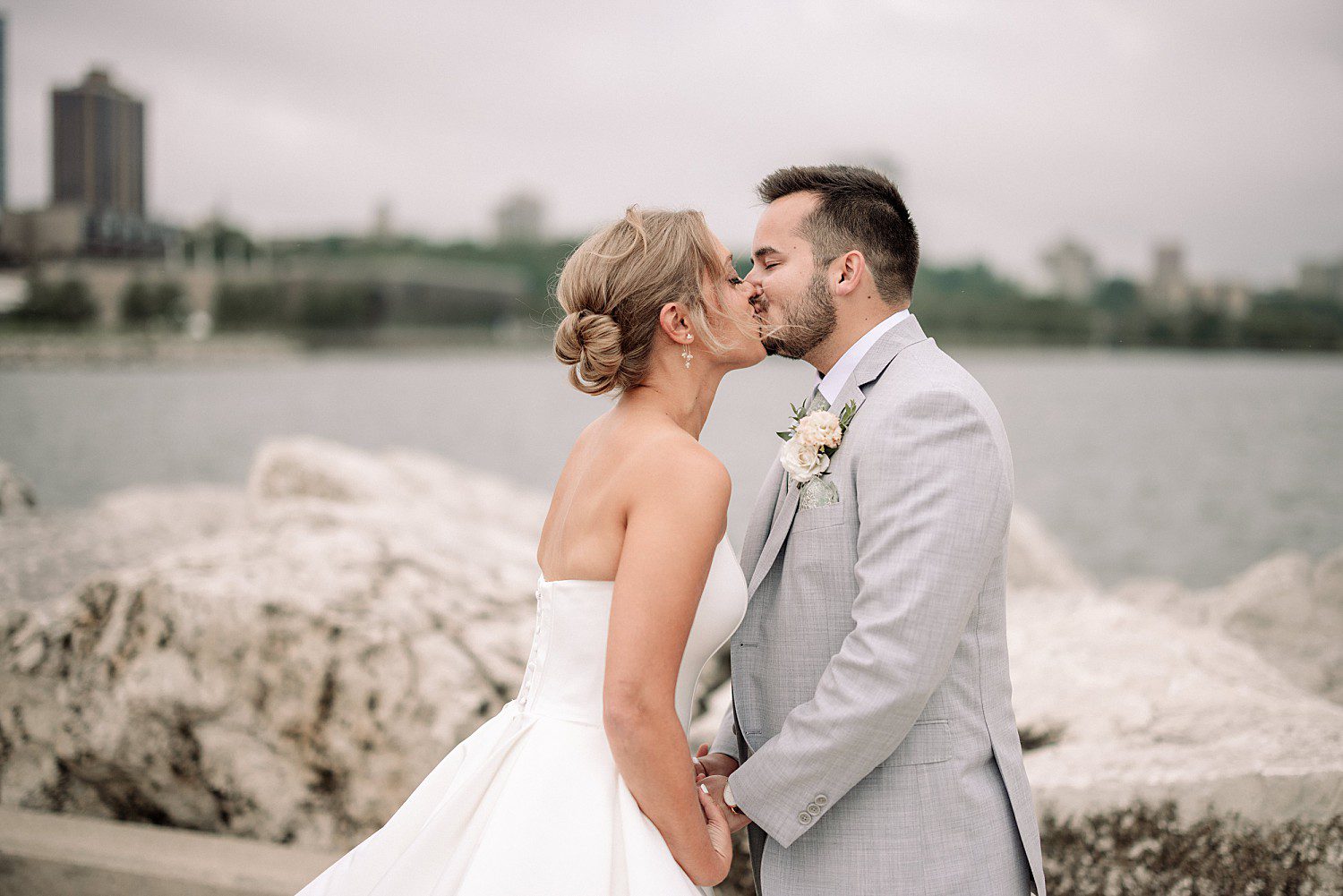 Tess and Grant's candid lakefront moment at the Discovery World wedding venue
