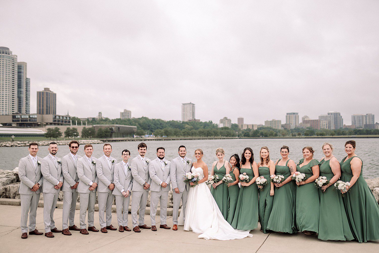 Tess and Grant's walking along the lakefront at their Discovery World Pavilion wedding