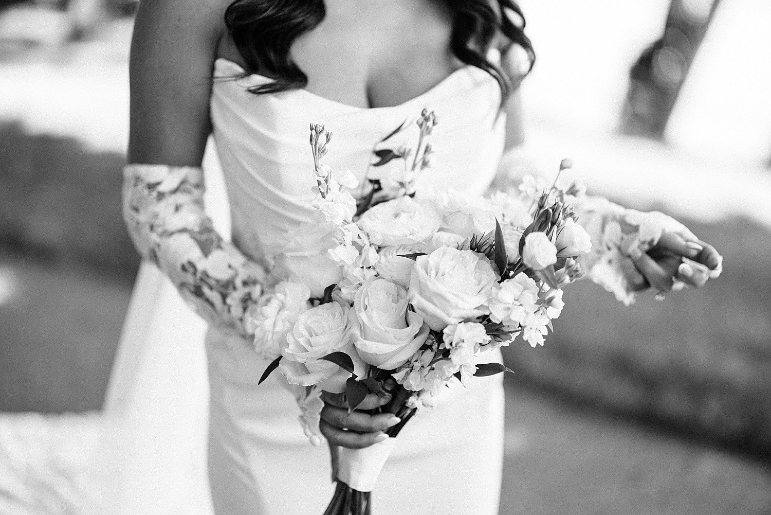 A black and white close-up of Jenna's white bridal bouquet at her Heidel House wedding
