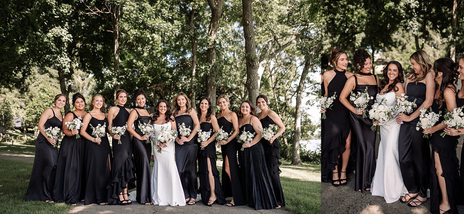 Jenna and her ten bridesmaids in black gowns posing under the trees at her Heidel House wedding
