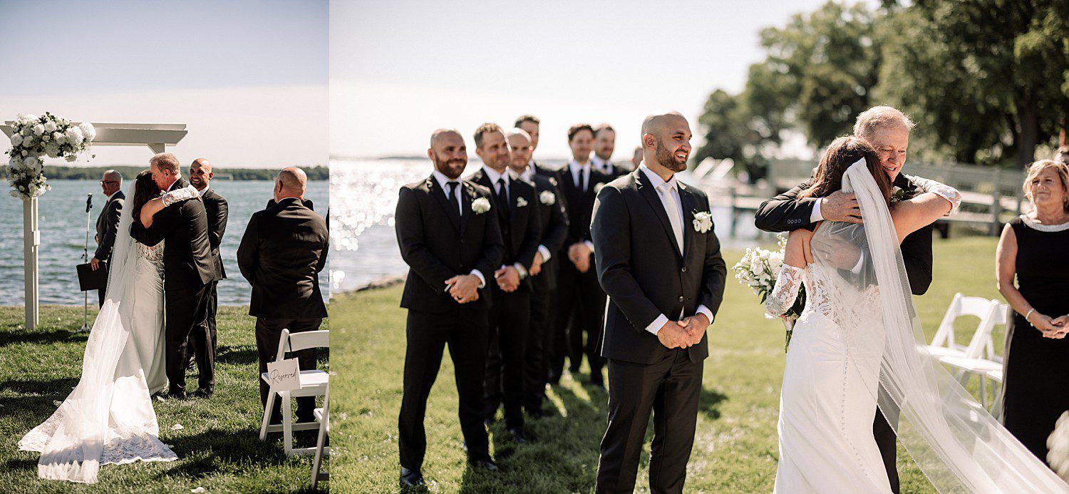 Jenna's dad embracing her as Josh and his groomsmen wait during the Heidel House wedding processional