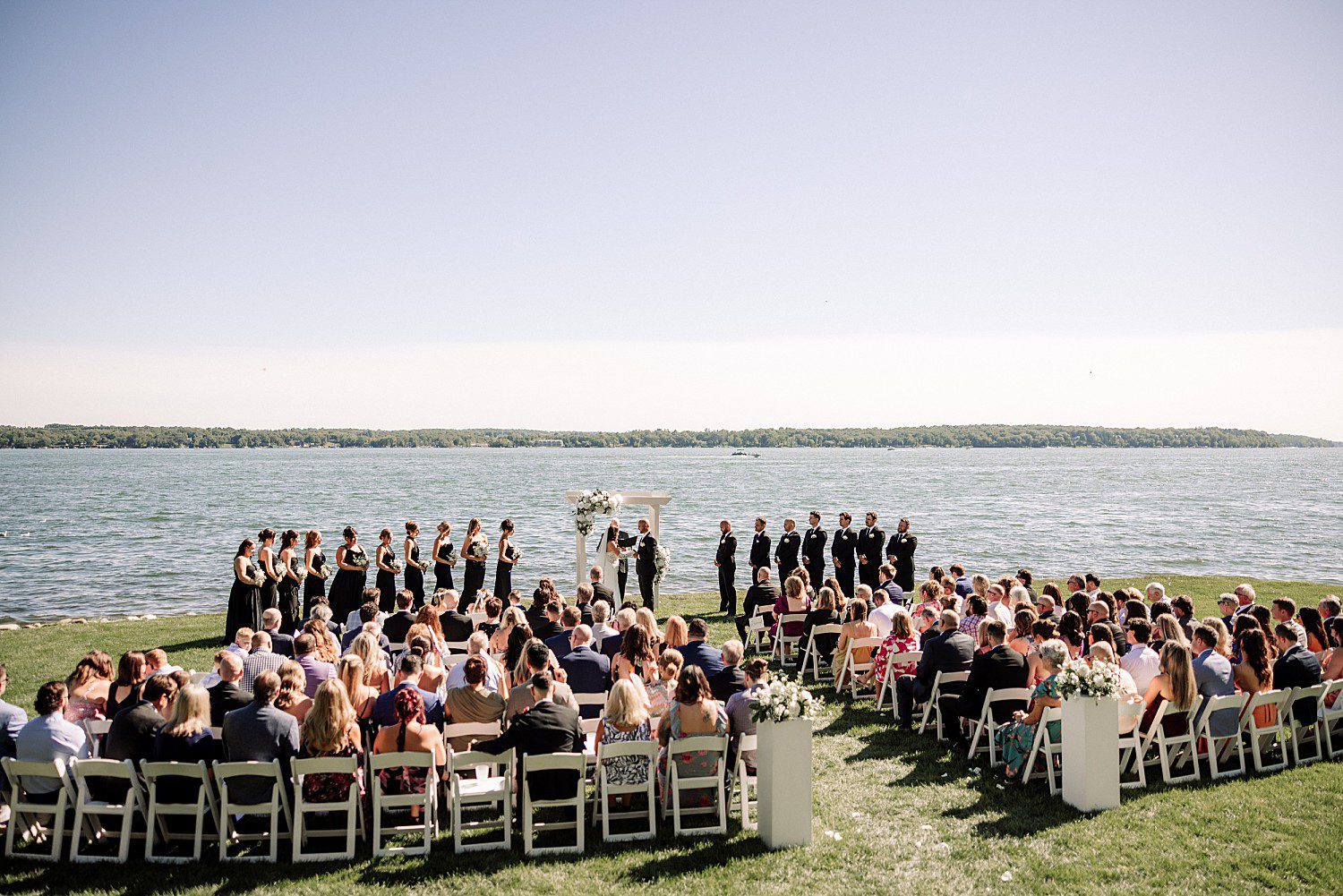 A wide view of Jenna and Josh's wedding party and guests during their lakeside Heidel House ceremony