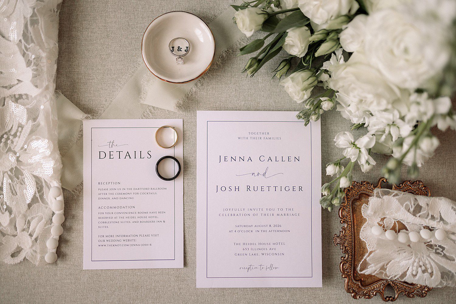 The wedding invitation suite and rings for Jenna and Josh's Heidel House wedding in Green Lake, WI