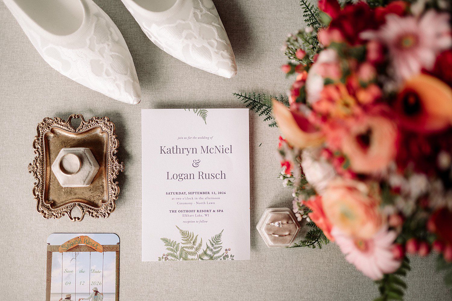 Kathryn and Logan's wedding invitation, heirloom ring box and coral bouquet at The Osthoff Resort in Elkhart Lake, Wisconsin