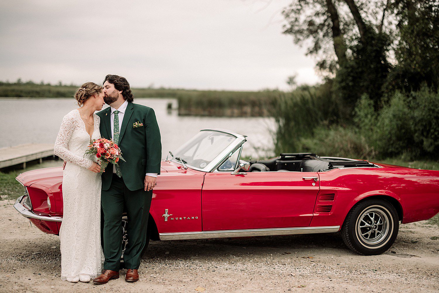 Kathryn and Logan's nose kiss beside the red 1967 Mustang at Sheboygan Marsh near Elkhart Lake, Wisconsin