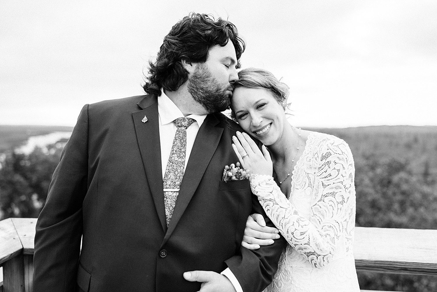 Black and white portrait of Logan kissing Kathryn's forehead at Sheboygan Marsh Tower near Elkhart Lake, Wisconsin