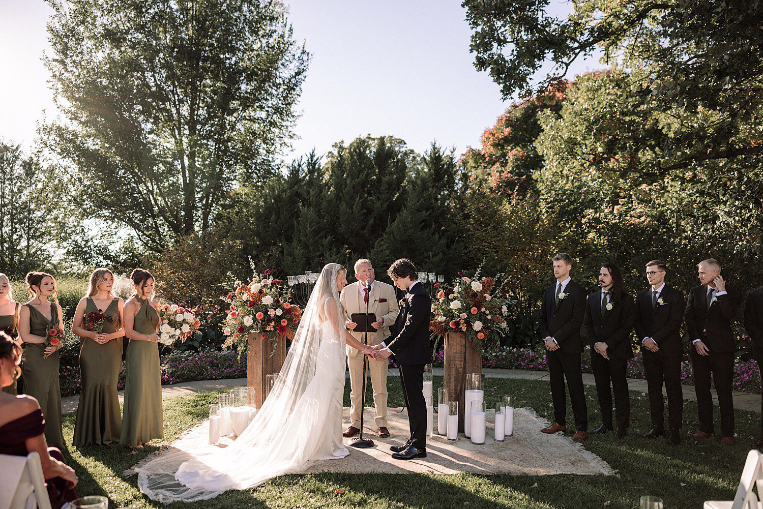 Noelle and Noah exchanging vows at their outdoor fall ceremony at Boerner Botanical Gardens in Hales Corners, Wisconsin