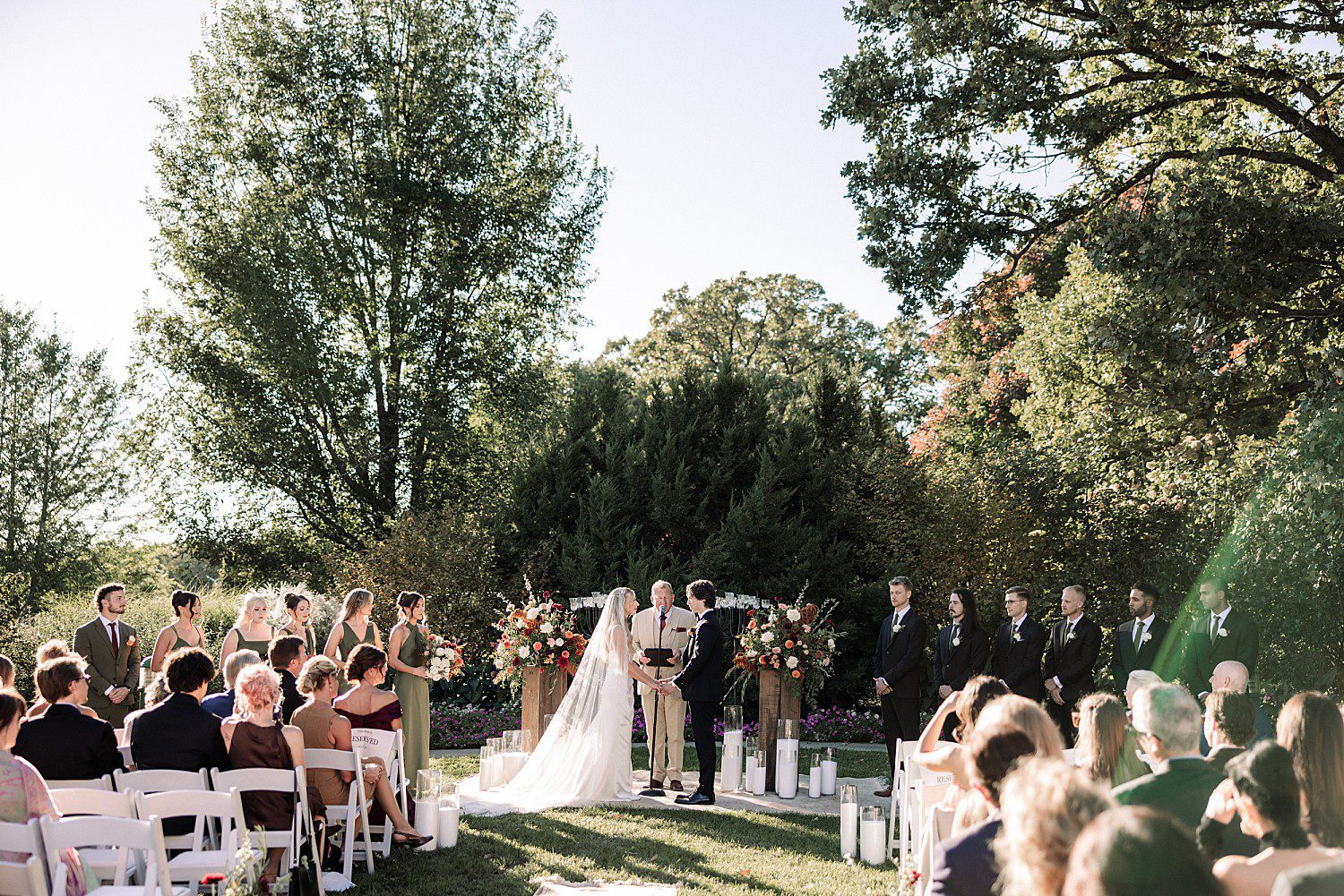 Guests watching Noelle and Noah's outdoor wedding ceremony at Boerner Botanical Gardens in Hales Corners, Wisconsin