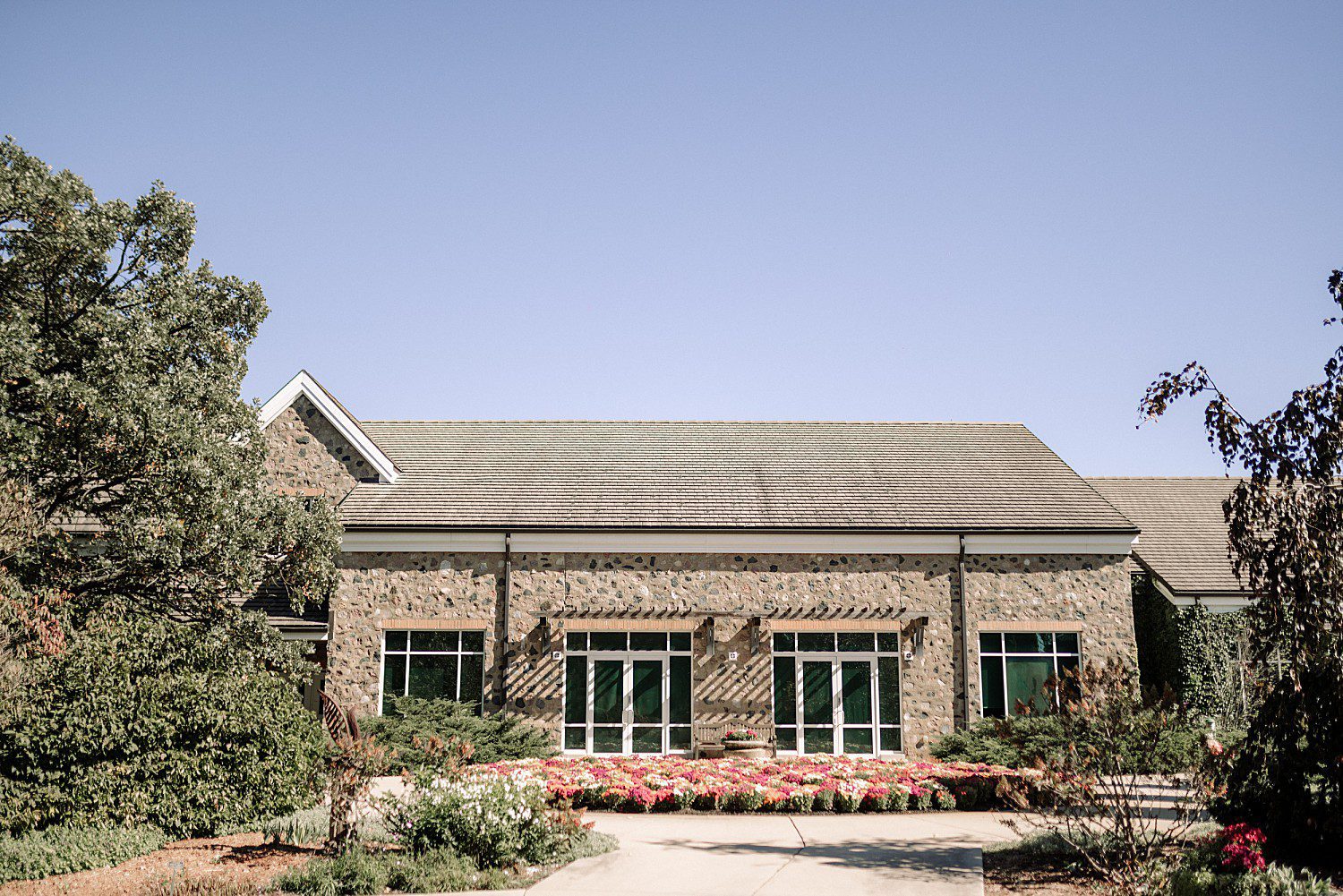 Stone building and fall flower beds on Noelle and Noah's wedding day at Boerner Botanical Gardens in Hales Corners, Wisconsin