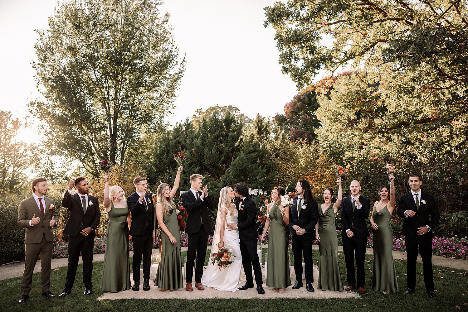 Noelle and Noah's wedding party cheering after the ceremony at Boerner Botanical Gardens in Hales Corners, Wisconsin